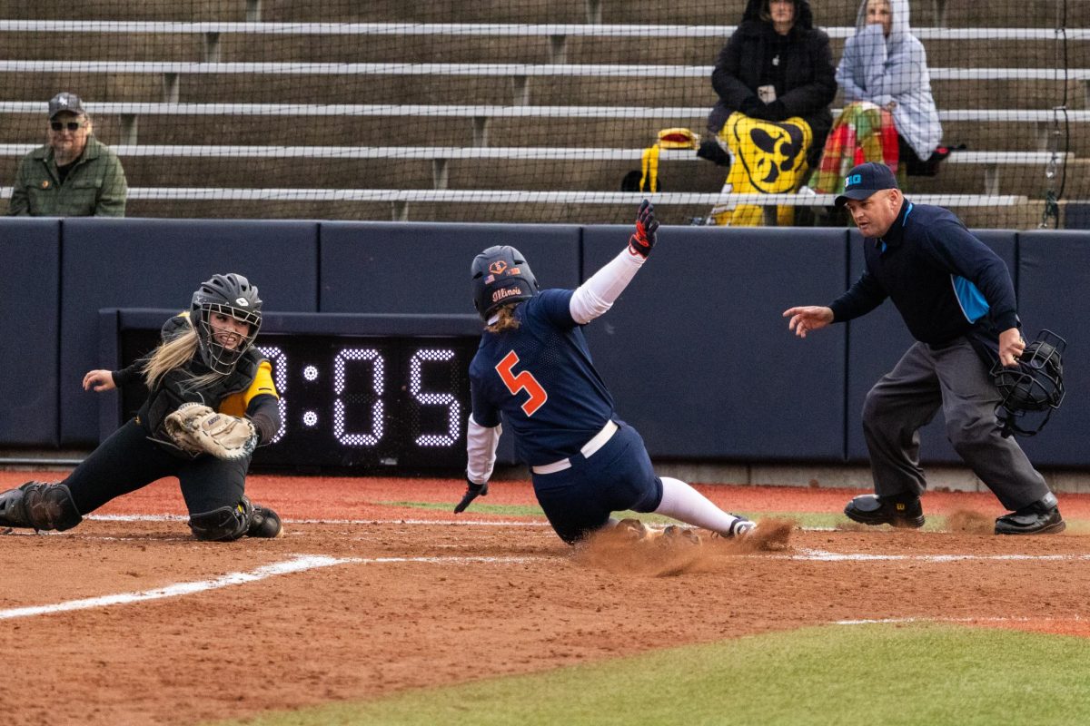 Junior infielder Adisyn Caryl slides into home safe on March 13 at the team's first home game of the season against Iowa. 