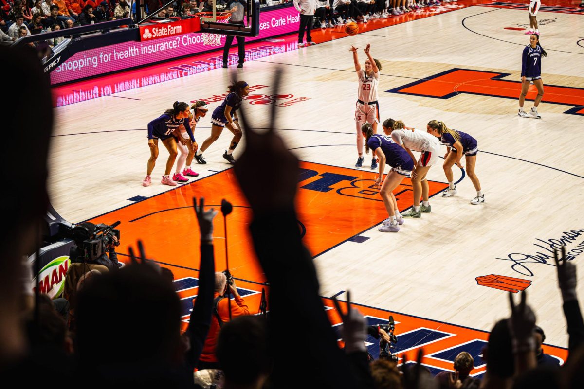 Sophomore forward Berry Wallace shoots a free throw in front of the rowdy Illinois band during the Illinois v. Northwestern game on Jan. 18. Illinois would go on to win by a final score of 74-71. 