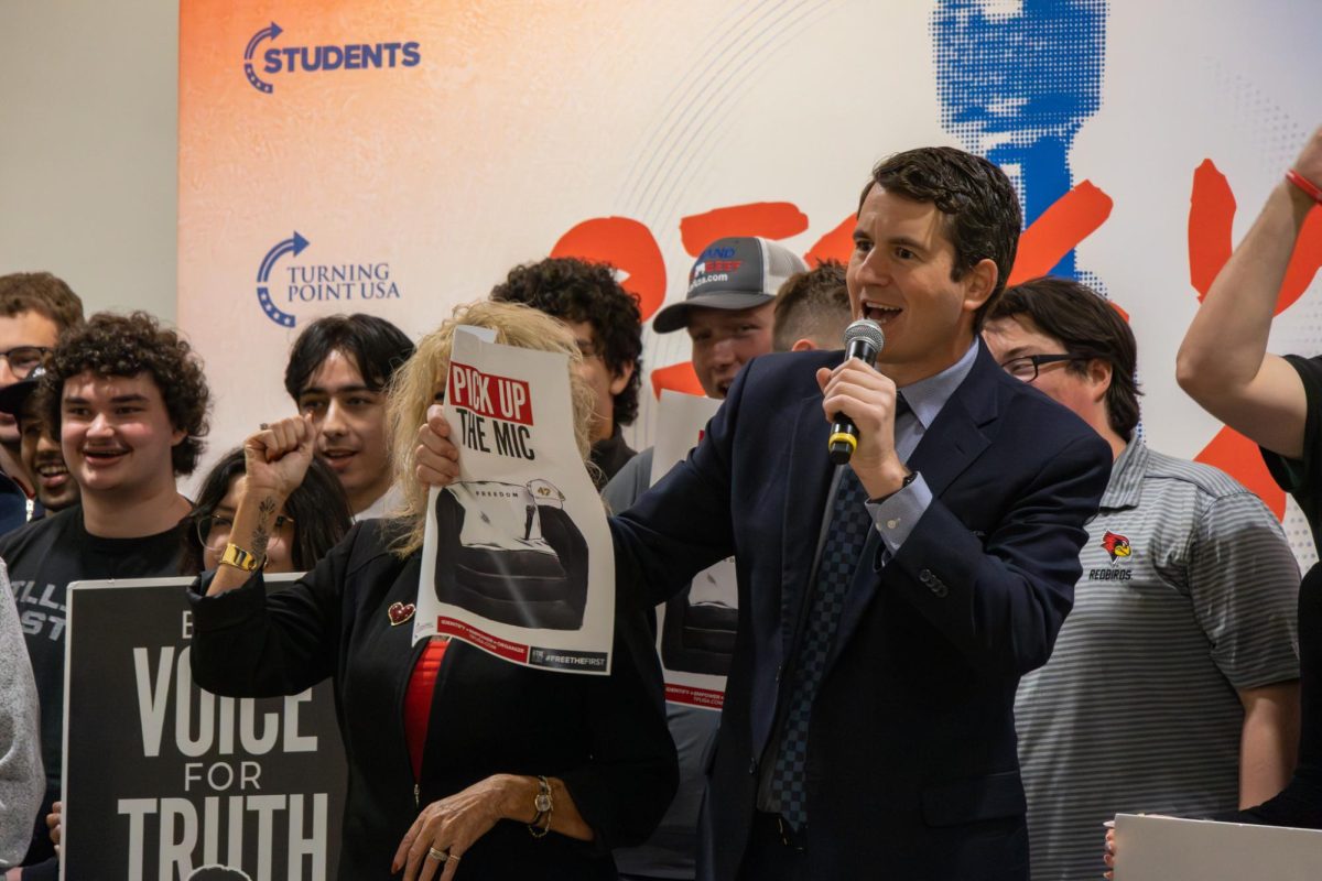Alex Stein leads supporters in a "USA" chant at the Illini Union on Wednesday, April 3. Stein is known for being a right-wing comedian often involved in public confrontations with well-known figures.