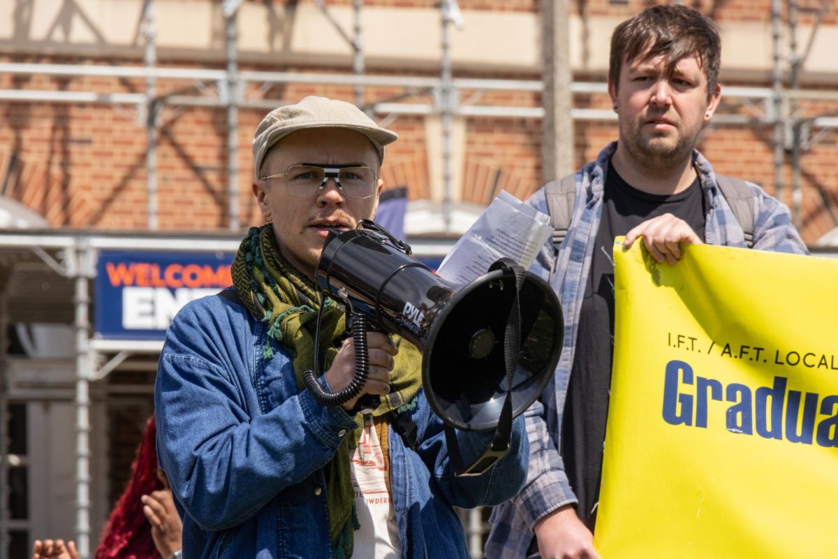 Thair Thursday, GEO member, speaks on the Main Quad during GEO’s ICE OUT rally on Wednesday afternoon. Labor unions and organizations affiliated with the University demanded it divest from companies doing business with immigration enforcement.