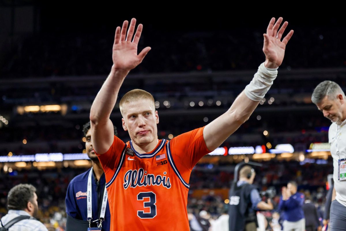 Graduate student forward Ben Humrichous acknowledges the Illini student section at Lucas Oil Stadium as he walks off the court for the final time in his college career. Illinois fell to UConn in the Final Four on April 4 in front of a packed football stadium, mostly full of its own fans.