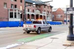 A University community service officer vehicle blocks northbound traffic on South Wright Street.