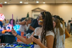 Nora Rafaty tried on a pair of sunglasses at another booth.