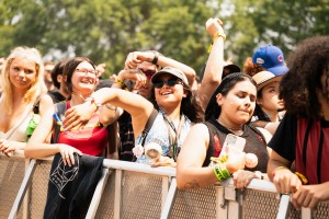 A festival goer happily jumps to the music of Skrillex.