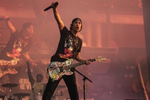 Vic Fuentes stretches his arm, out with microphone in hand, to the crowd attending as the band plays for Lollapalooza on Sunday.