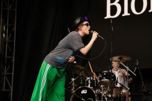 Blondshell looks at her backing band members while performing.