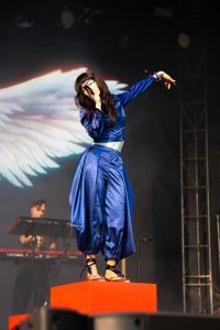 Mica Tenenbaum stands tall on her stage prop and delivers enchanting vocals to begin her set.