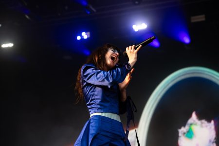 Tenenbaum clutches the microphone and delivers a powerful note.