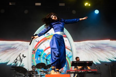 Tenenbaum stands on her stage prop and dances to the music.