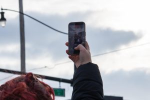 As the protest made its way down Green Street to the intersection at First Street, it garnered attention from the sidewalks. Many onlookers took pictures or recorded short videos on their phones as the crowd passed by.
