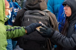 Protesters pass hand warmers and water bottles out to each other, fighting the freezing winter temperatures on Jan. 30.