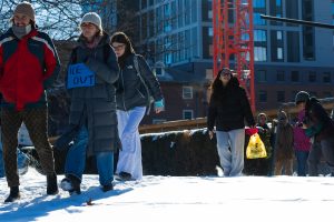 People walk toward the Alma Mater statue, where protesters were instructed to meet for a mass walkout on Jan. 30.