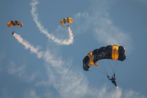 The U.S. Army Golden Knights Parachute Team descends onto Zuppke Field before the Homecoming game versus Southern California on Sept. 27, 2025.