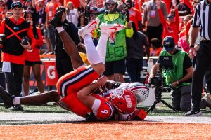 Senior quarterback Luke Altmyer is tackled, losing an opportunity to score for Illinois against Ohio State on Oct. 11, 2025. Illinois lost 34-16.