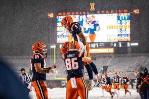 Sophomore runningback Ca’Lil Valentine is lifted up by teammates after scoring a touchdown against Northwestern on Nov. 29, 2025. Illinois went on to win the game 20-13.