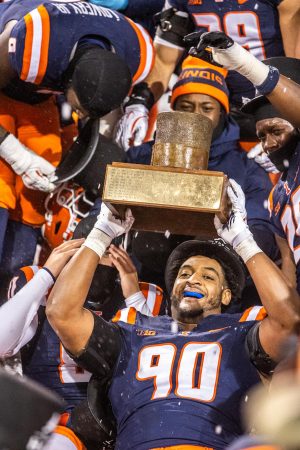 Senior defensive lineman James Thompson Jr. hoists “The Hat” after defeating Northwestern in a snowy evening matchup.