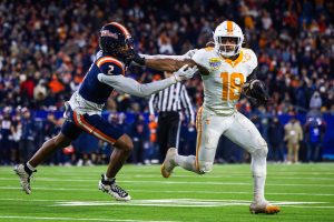 Tennessee redshirt sophomore runningback DeSean Bishop runs past junior defensive back Saboor Karriem to score a third-quarter touchdown at the Music City Bowl.