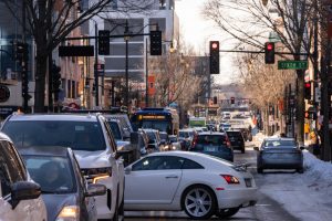 Cars begin to attempt U-turns as traffic backs up for blocks on E. Green Street as anti-ICE protesters block the intersection of Green and Wright streets on Jan. 30.