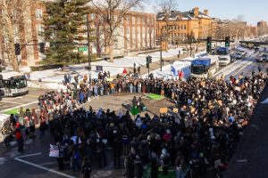 MTD buses stop in the road as anti-ICE protesters block the intersection of Green and Wright Streets on Jan. 30.