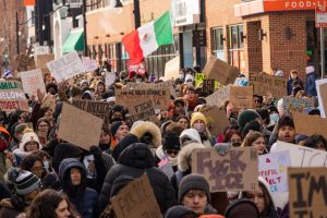 Hundreds of protesters block off both lanes as they march down Green Street on Jan. 30.