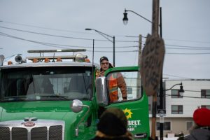 Protesters blocking the street engage in a with a truck driver on Jan. 30. The truck driver exited his vehicle to voice his opinions against the protest.