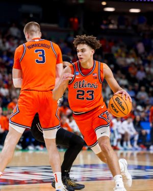 Illinois freshman guard Keaton Wagler dribbles around a screen set by graduate student forward Ben Humrichous on a VCU defender March 21.