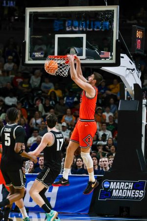 Junior center Tomislav Ivišić dunks during Illinois’ March 21 win over VCU in the second round of the NCAA tournament. Ivišić had his third double-double of the season, tallying 14 points and 11 rebounds.