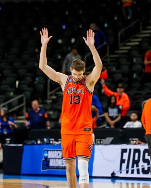 Junior center Tomislav Ivišić acknowledges the Illini crowd at Bon Secours Wellness Arena in Greenville, South Carolina, after defeating the Rams in the second round of March Madness.