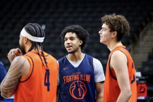 Freshman guard Brandon Lee speaks with his teammates, freshman guard Keaton Wagler and senior guard Kylan Boswell, during Illinois’ open practice in Greenville, South Carolina, March 19.