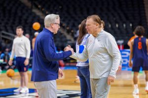 Penn head coach Fran McCaffrey (left) and Illinois head coach Brad Underwood (right) shake hands at Illinois’ open practice March 18 in Greenville, South Carolina. The two head coaches faced off March 19 at Bon Secours Wellness Arena in the first round of the NCAA tournament.