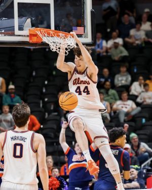 Junior center Zvonimir Ivišić throws down a dunk off an alley-oop in the second half of Illinois’ first-round March Madness win over Penn on March 19. Ivišić had 6 points in the game.