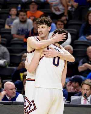 Junior center Zvonimir Ivišić embraces freshman forward David Mirković March 19 as he heads to the bench during his 29-point, 17-rebound March Madness debut.