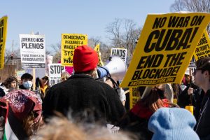 Protesters at the No Kings 3 circle around a speaker in downtown Urbana on Saturday afternoon.