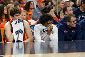 Freshman forward David Mirkovic and freshman guard Brandon Lee watch the final minutes of Illinois' 71-62 loss to UConn from the bench.